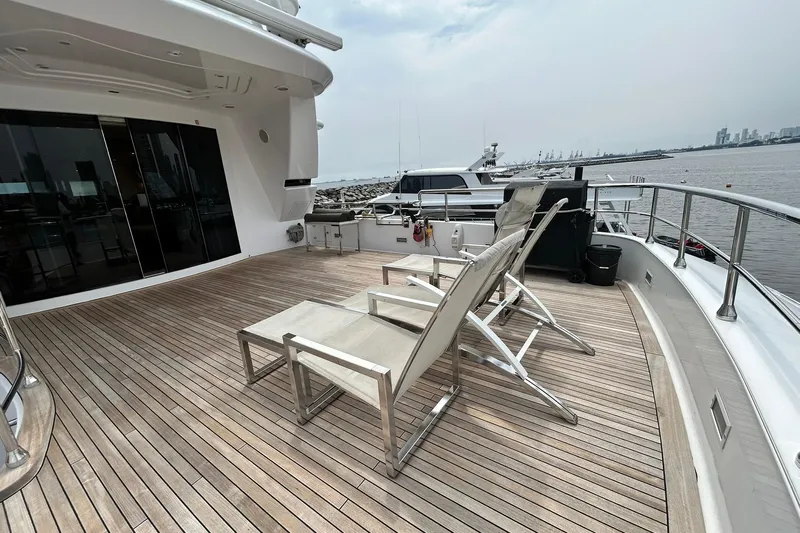 Sunshine Yacht Photos Pics Spacious deck of 2010 Versilcraft Euroyacht Planet 125S with lounge chairs and ocean view.