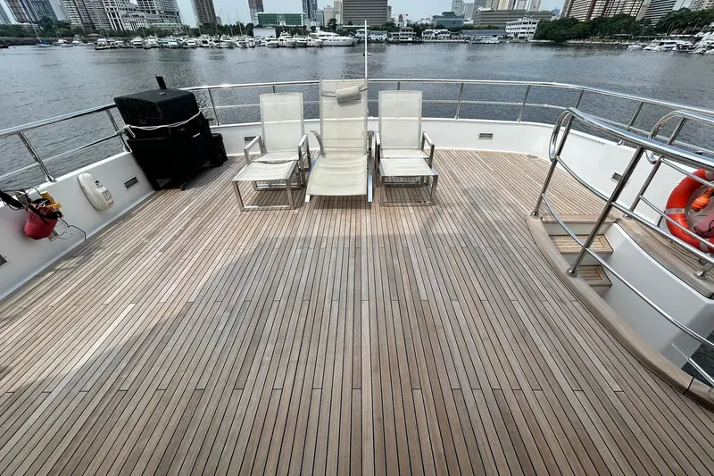 Sunshine Yacht Photos Pics Spacious deck of 2010 Versilcraft Euroyacht Planet 125S Hardtop with cityscape view.