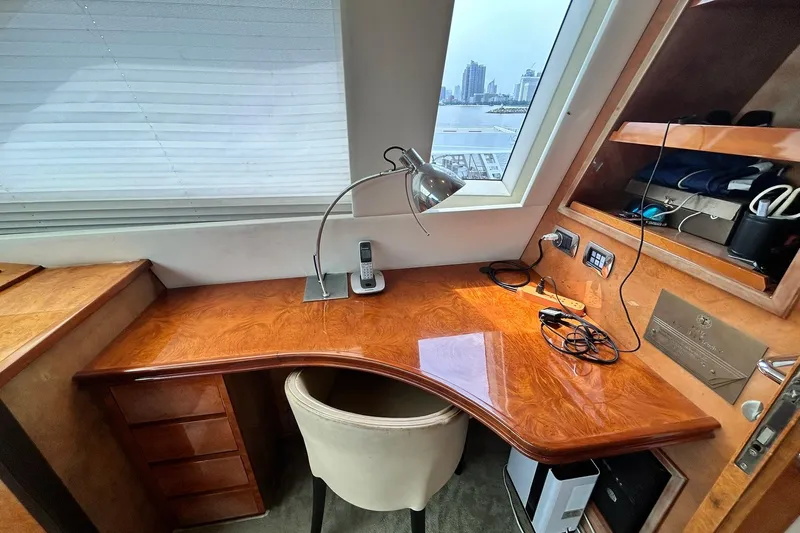 Sunshine Yacht Photos Pics Luxurious Versilcraft Euroyacht 125S desk area with city view, featuring elegant wood finish.
