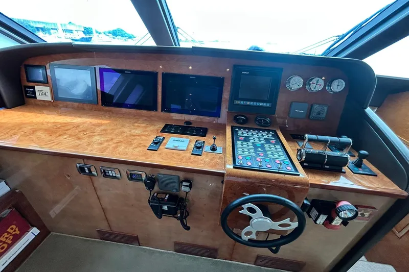 Sunshine Yacht Photos Pics Control panel of 2010 Versilcraft Euroyacht Planet 125S Hardtop with navigation screens and steering wheel.