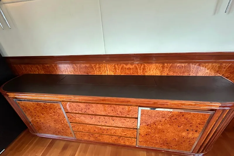 Sunshine Yacht Photos Pics Luxurious wood cabinetry on 2010 Versilcraft Euroyacht Planet 125S Hardtop, featuring elegant design.