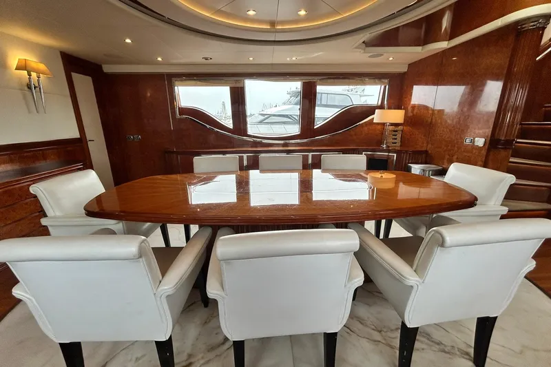 Sunshine Yacht Photos Pics Luxurious dining area on 2010 Versilcraft Euroyacht Planet 125S, featuring elegant wood and white chairs.