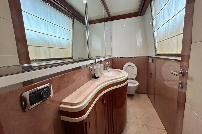 Sunshine Yacht Photos Pics Luxurious bathroom in 2010 Versilcraft Euroyacht Planet 125S, featuring elegant wood and marble finishes.