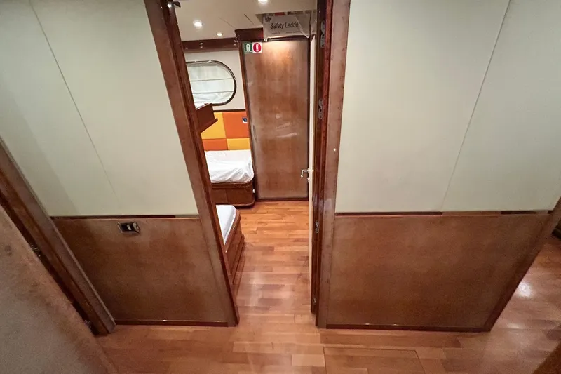 Sunshine Yacht Photos Pics Interior view of 2010 Versilcraft Euroyacht Planet 125S Hardtop, featuring wooden flooring and cabin doors.