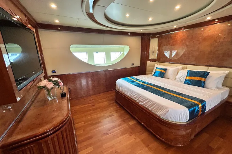 Sunshine Yacht Photos Pics Luxurious bedroom on 2010 Versilcraft Euroyacht Planet 125S, featuring elegant wood finishes and modern decor.