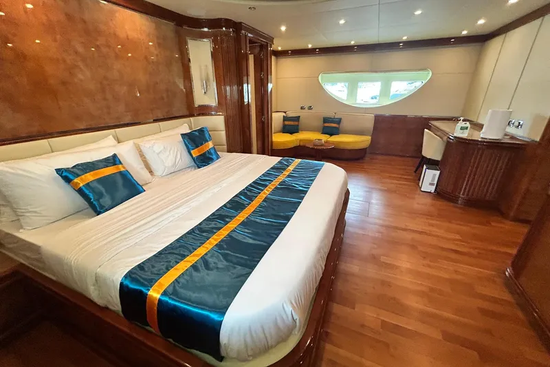 Sunshine Yacht Photos Pics Luxurious bedroom interior of 2010 Versilcraft Euroyacht Planet 125S Hardtop with elegant wood finishes.