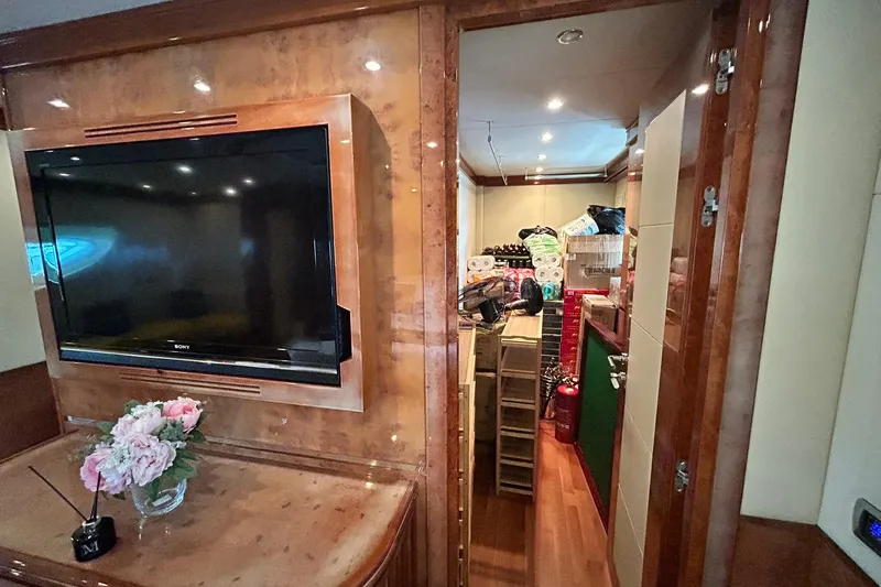 Sunshine Yacht Photos Pics Luxurious interior of 2010 Versilcraft Euroyacht Planet 125S with TV and storage room.