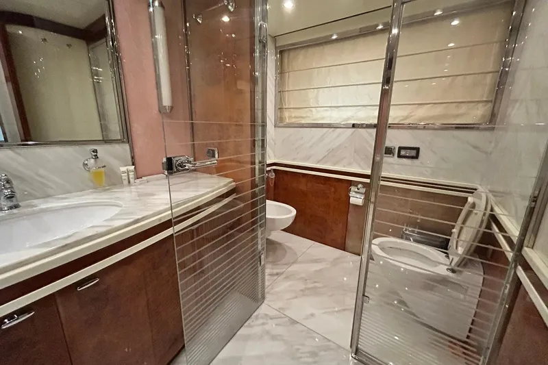 Sunshine Yacht Photos Pics Luxurious bathroom in 2010 Versilcraft Euroyacht Planet 125S Hardtop with marble and wood finishes.