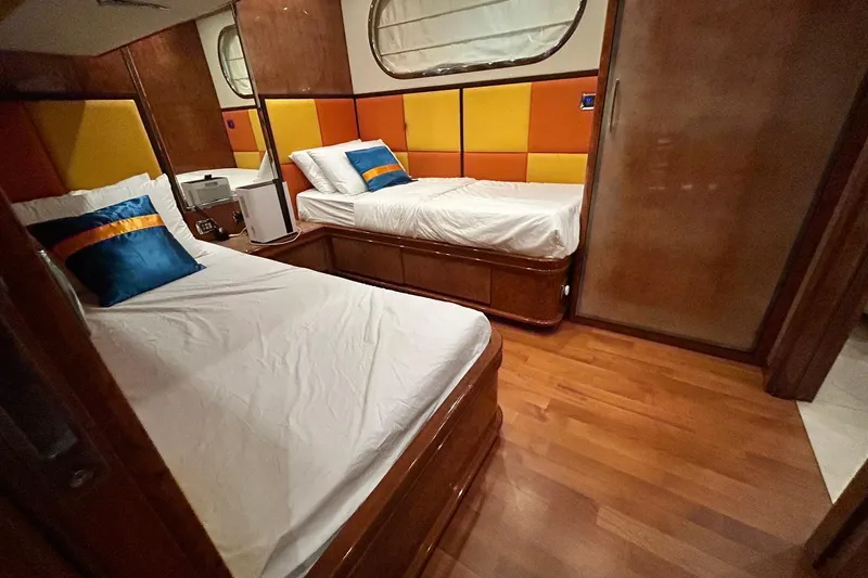 Sunshine Yacht Photos Pics Luxurious cabin interior of 2010 Versilcraft Euroyacht Planet 125S with twin beds and vibrant decor.