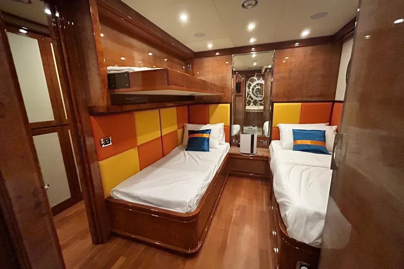 Sunshine Yacht Photos Pics Luxurious twin cabin on 2010 Versilcraft Euroyacht Planet 125S, featuring vibrant decor and modern amenities.