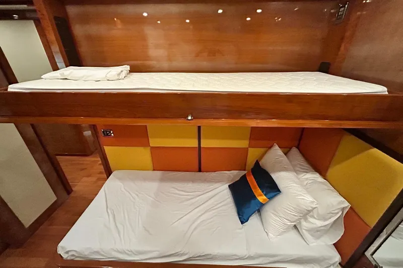 Sunshine Yacht Photos Pics Bunk beds in 2010 Versilcraft Euroyacht Planet 125S, featuring colorful padded wall panels.