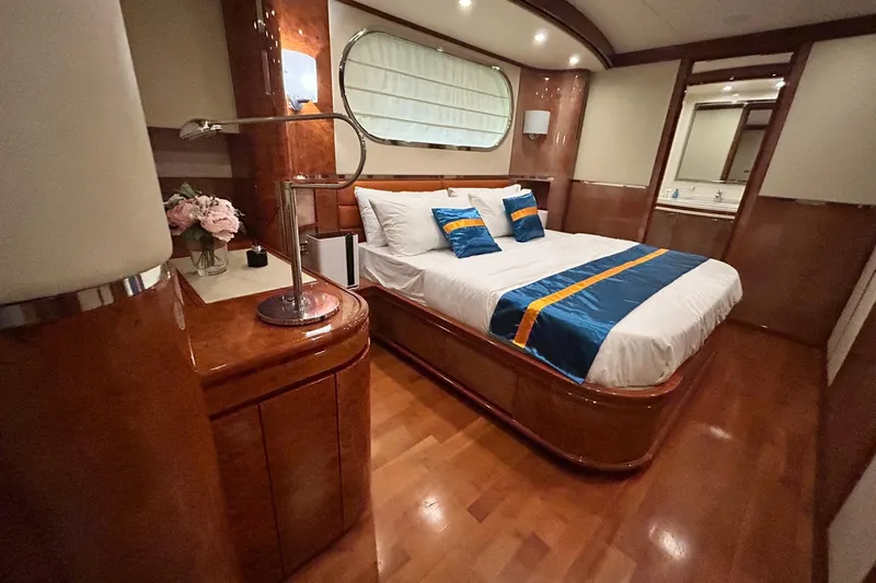 Sunshine Yacht Photos Pics Luxurious bedroom interior on 2010 Versilcraft Euroyacht Planet 125S, featuring elegant wood finishes.