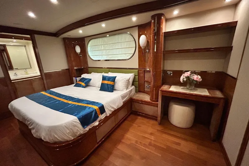 Sunshine Yacht Photos Pics Luxurious bedroom interior of 2010 Versilcraft Euroyacht Planet 125S Hardtop with elegant wood finishes.