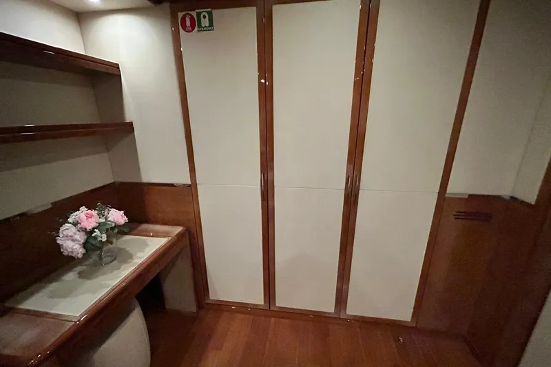 Sunshine Yacht Photos Pics Luxurious interior of 2010 Versilcraft Euroyacht Planet 125S, featuring elegant wood finishes and floral decor.