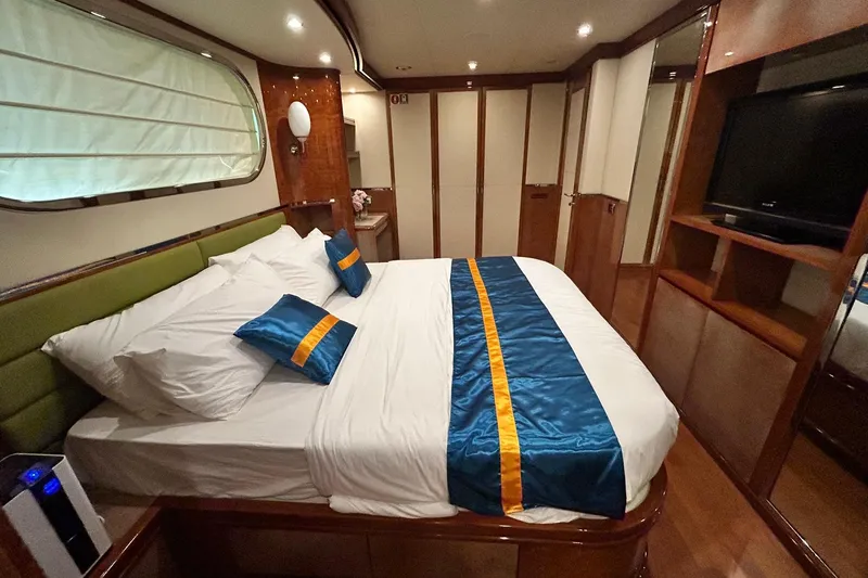 Sunshine Yacht Photos Pics Luxurious bedroom interior of 2010 Versilcraft Euroyacht Planet 125S Hardtop with elegant bedding.