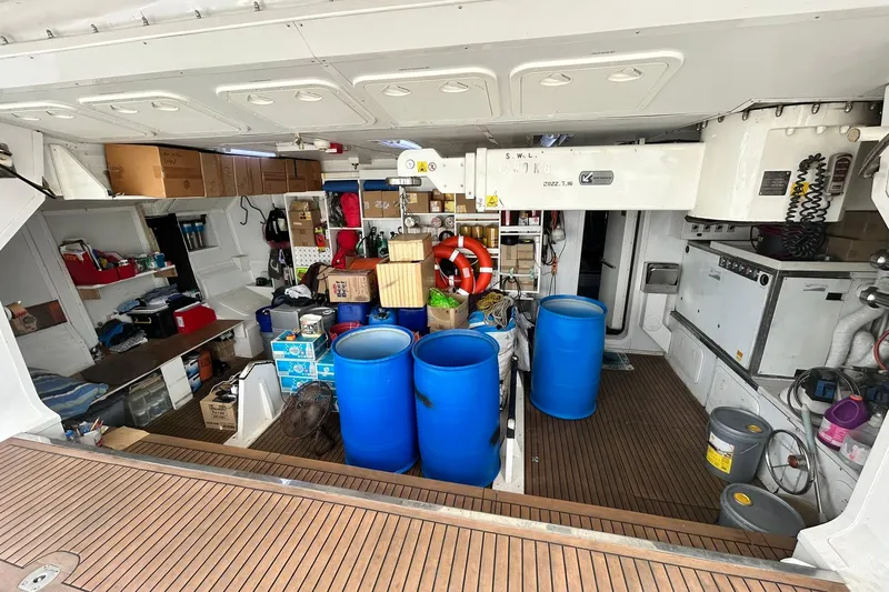 Sunshine Yacht Photos Pics Storage area of 2010 Versilcraft Euroyacht Planet 125S with blue barrels and supplies.
