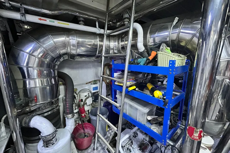 Sunshine Yacht Photos Pics Engine room of 2010 Versilcraft Euroyacht Planet 125S, featuring pipes and tools.