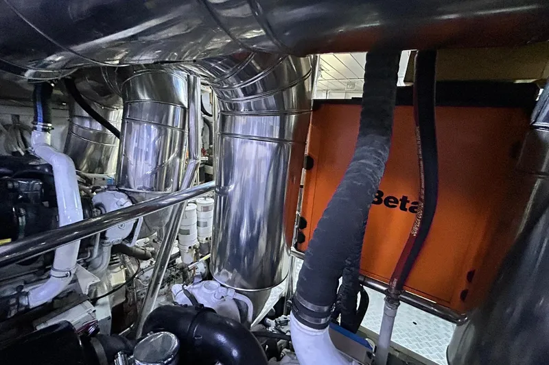 Sunshine Yacht Photos Pics Engine room of 2010 Versilcraft Euroyacht Planet 125S Hardtop with metallic pipes and machinery.