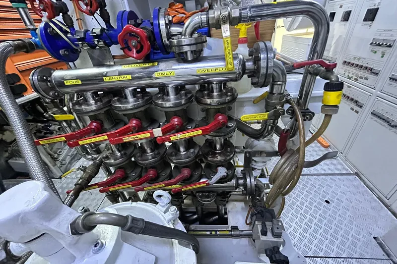 Sunshine Yacht Photos Pics Engine room of 2010 Versilcraft Euroyacht Planet 125S, showcasing complex piping and valves.