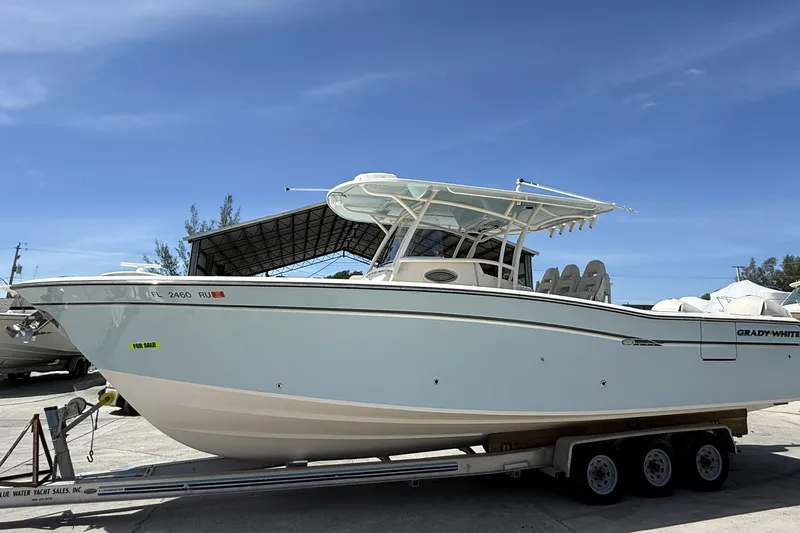 336-311 Brokerage Ron Yacht Photos Pics 2018 Grady-White Canyon 336 boat on trailer, for sale, under clear blue sky.