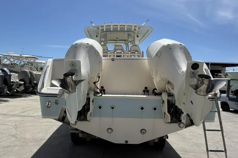 336-311 Brokerage Ron Yacht Photos Pics 2018 Grady-White Canyon 336 boat with dual outboard engines, docked under clear blue sky.