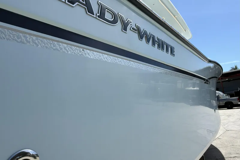 336-311 Brokerage Ron Yacht Photos Pics 2018 Grady-White Canyon 336 boat side view with logo in sunlight.