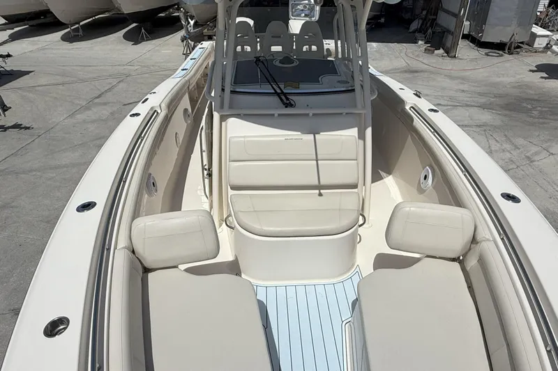 336-311 Brokerage Ron Yacht Photos Pics 2018 Grady-White Canyon 336 boat interior with seating and console, docked outdoors.
