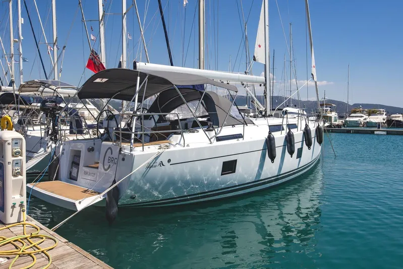  Yacht Photos Pics 2022 Hanse 458 yacht docked in marina, clear blue water, sunny day.