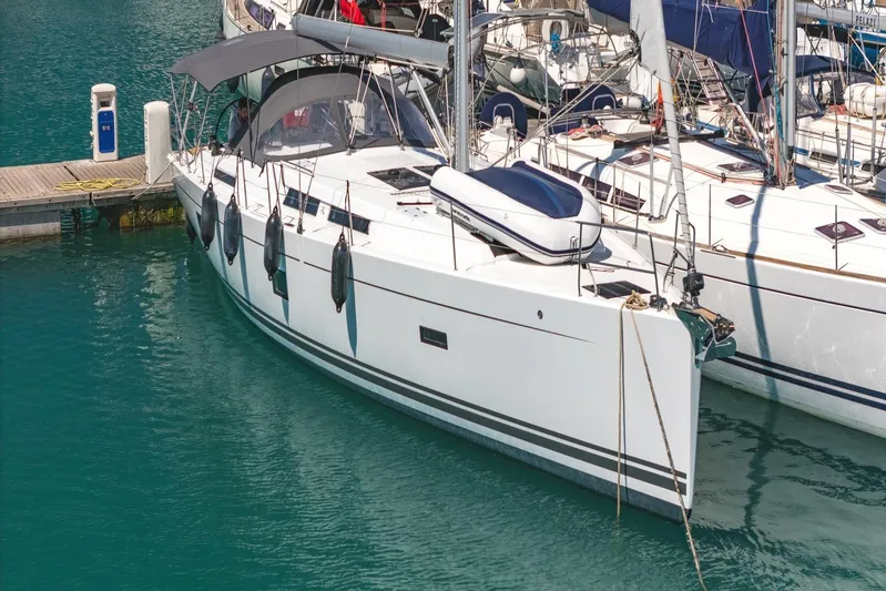  Yacht Photos Pics Sleek 2022 Hanse 458 yacht docked in a marina, featuring modern design and white hull.