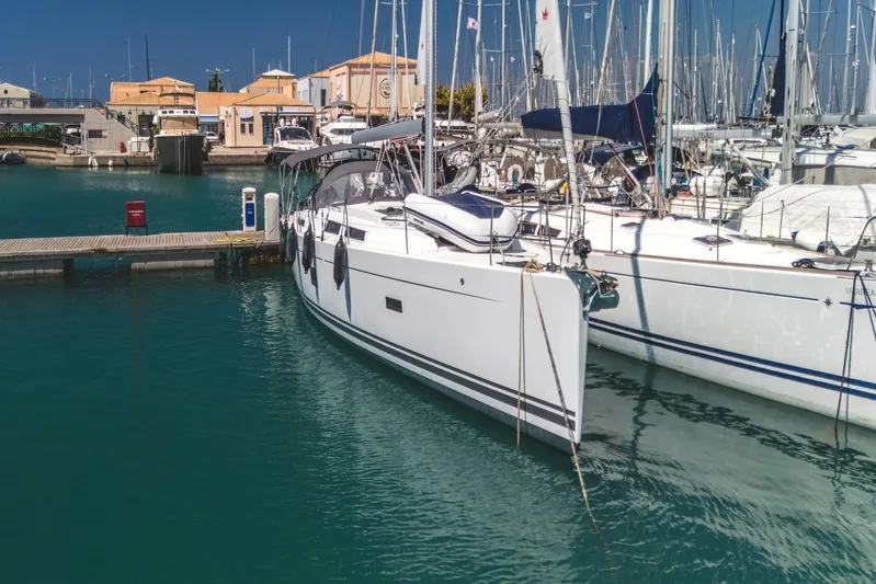  Yacht Photos Pics 2022 Hanse 458 yacht docked in a marina, surrounded by other sailboats.