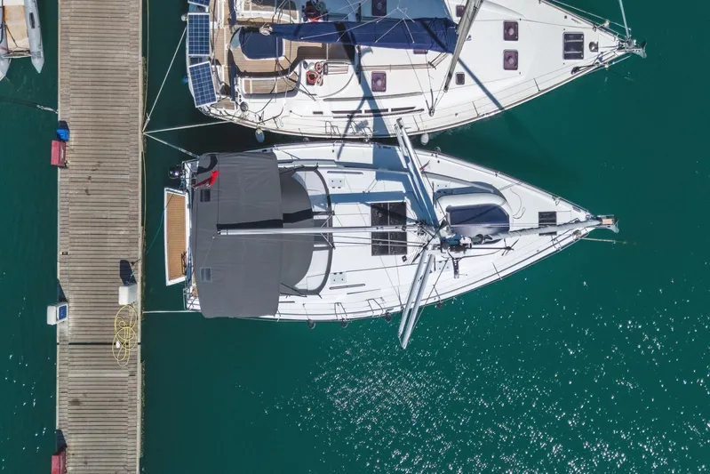  Yacht Photos Pics Aerial view of 2022 Hanse 458 yacht docked at marina, turquoise water.