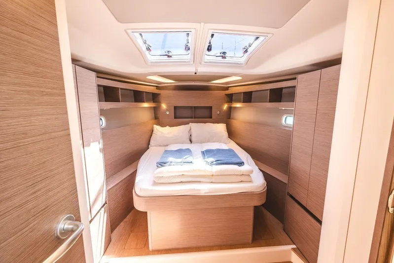  Yacht Photos Pics Luxurious 2022 Hanse 458 yacht cabin with cozy bed and modern wood finish.