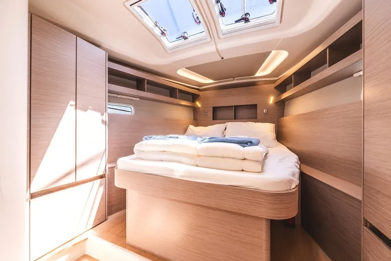  Yacht Photos Pics Luxurious cabin interior of 2022 Hanse 458 yacht with skylight and cozy bed.