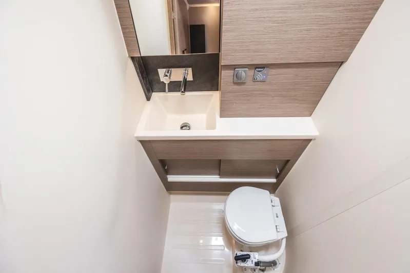  Yacht Photos Pics Compact bathroom in 2022 Hanse 458 yacht with modern sink and toilet.