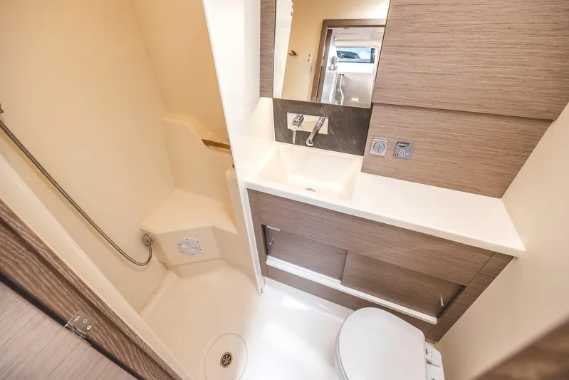  Yacht Photos Pics Modern bathroom in 2022 Hanse 458 yacht with sleek fixtures and wood accents.