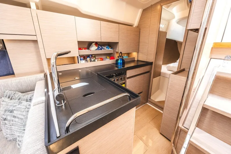 Yacht Photos Pics Modern kitchen interior of 2022 Hanse 458 yacht with sleek cabinetry and appliances.