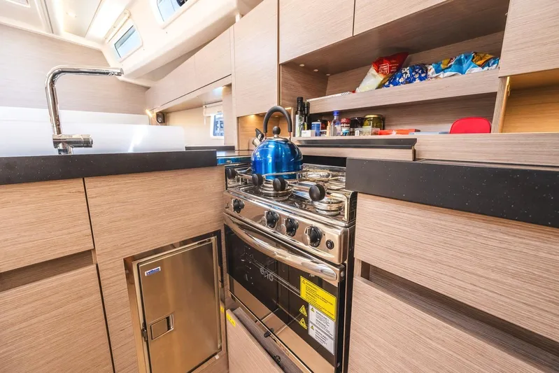  Yacht Photos Pics Modern kitchen interior of 2022 Hanse 458 yacht with stove and storage.