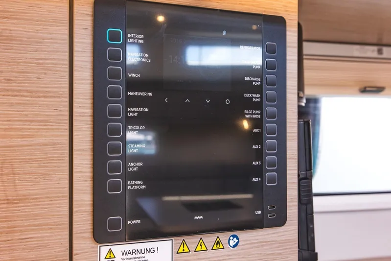  Yacht Photos Pics Control panel on 2022 Hanse 458 yacht, featuring various system buttons and warning labels.