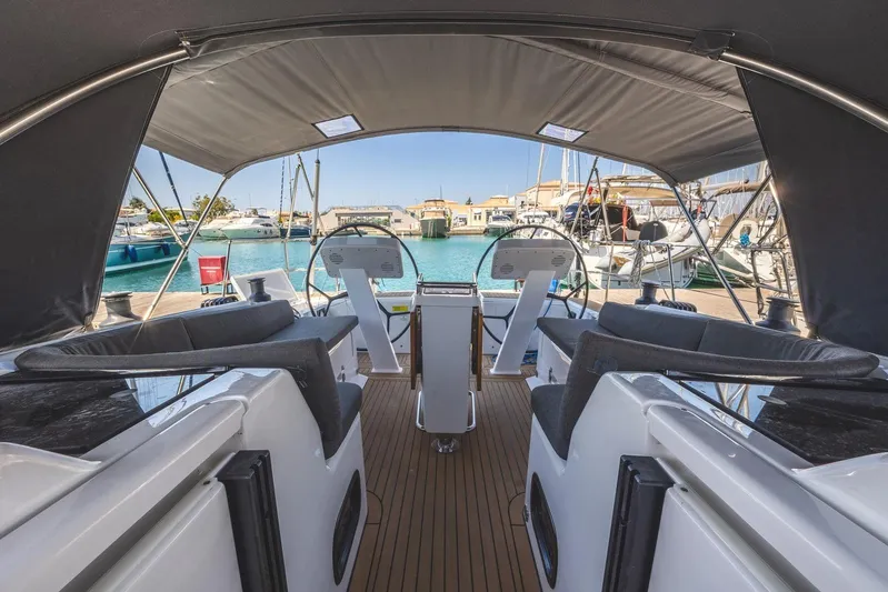  Yacht Photos Pics Interior view of 2022 Hanse 458 yacht cockpit with marina backdrop.