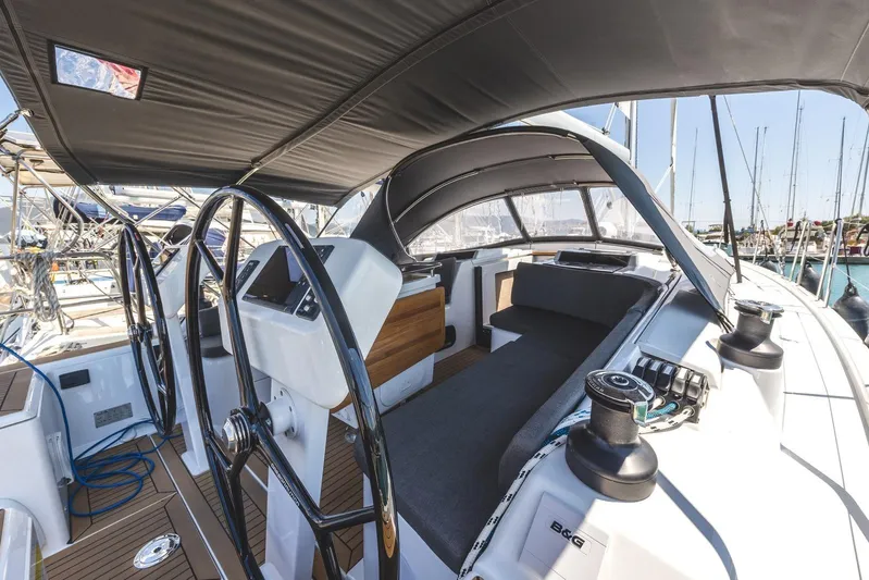  Yacht Photos Pics 2022 Hanse 458 yacht cockpit with dual steering wheels and spacious seating area.
