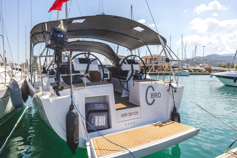  Yacht Photos Pics 2022 Hanse 458 yacht docked in marina, featuring dual steering wheels and sunshade.