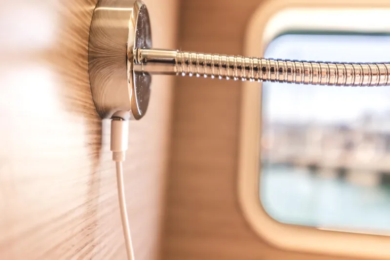  Yacht Photos Pics Close-up of a charging cable plugged into a wall socket on a 2022 Hanse 458 yacht.