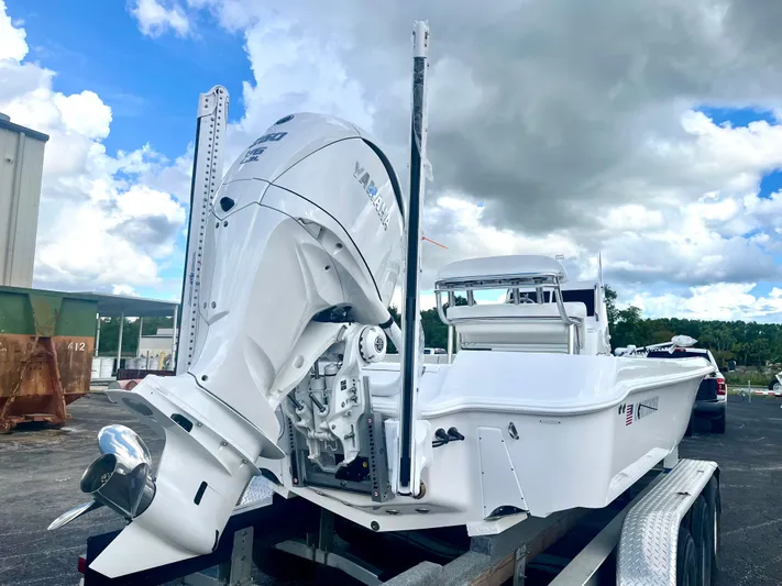  Yacht Photos Pics 2025 Contender 26 Bay boat on trailer under cloudy sky.