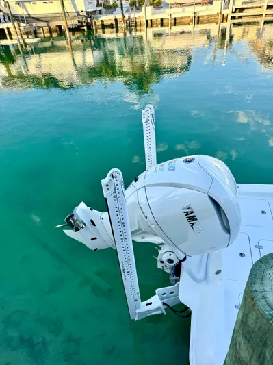  Yacht Photos Pics 2025 Contender 26 Bay boat with Yamaha engine in clear turquoise water.