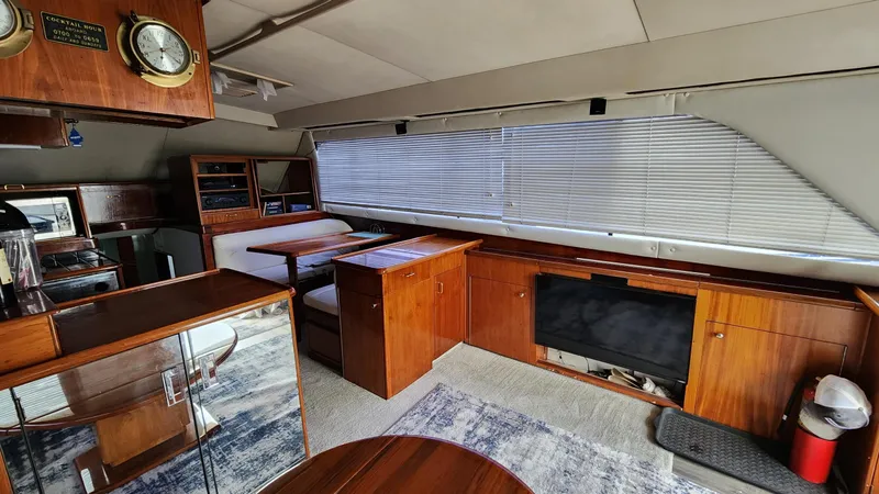 Reel Easy Yacht Photos Pics Interior of 1989 Ocean Yachts 55, featuring wood cabinetry and seating area.