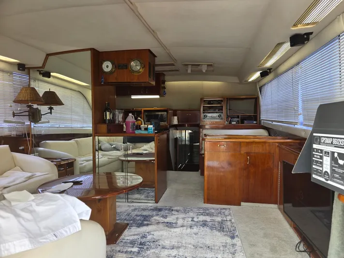 Reel Easy Yacht Photos Pics Interior of a 1989 Ocean Yachts 55, featuring wood cabinetry and comfortable seating.