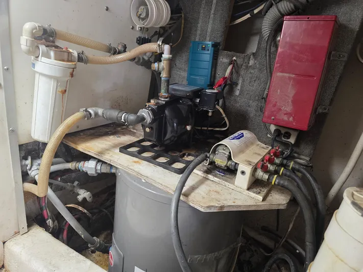 Reel Easy Yacht Photos Pics Engine room of a 1989 Ocean Yachts 55, featuring mechanical components and hoses.