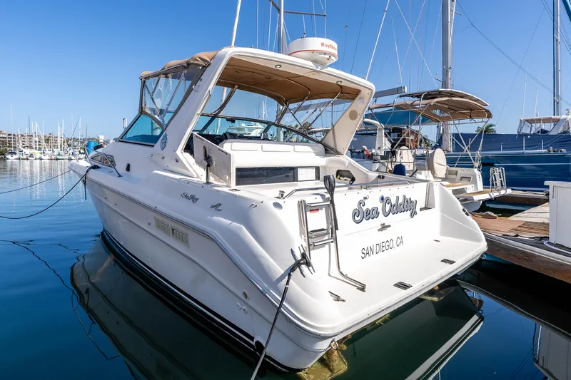 Sea Oddity Yacht Photos Pics 1991 Sea Ray 330 Sundancer docked in San Diego marina, clear blue sky.