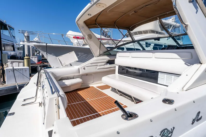 Sea Oddity Yacht Photos Pics 1991 Sea Ray 330 Sundancer yacht with spacious deck and seating at marina.