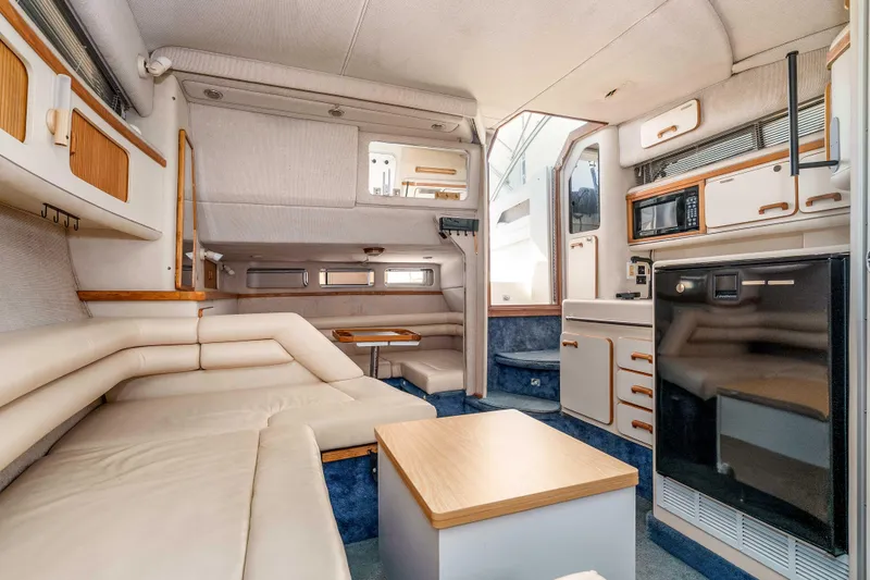 Sea Oddity Yacht Photos Pics Interior of 1991 Sea Ray 330 Sundancer yacht with modern kitchen and seating area.